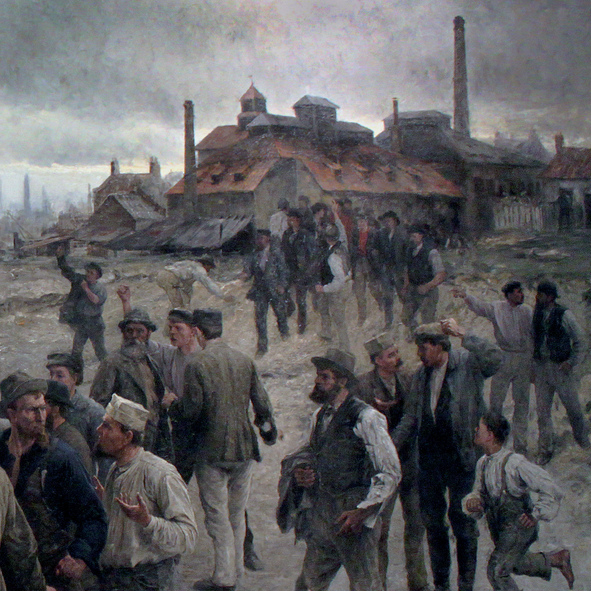 Industriarbetare som går iväg från en fabrik i ett dystert och rökigt industrilandskap.