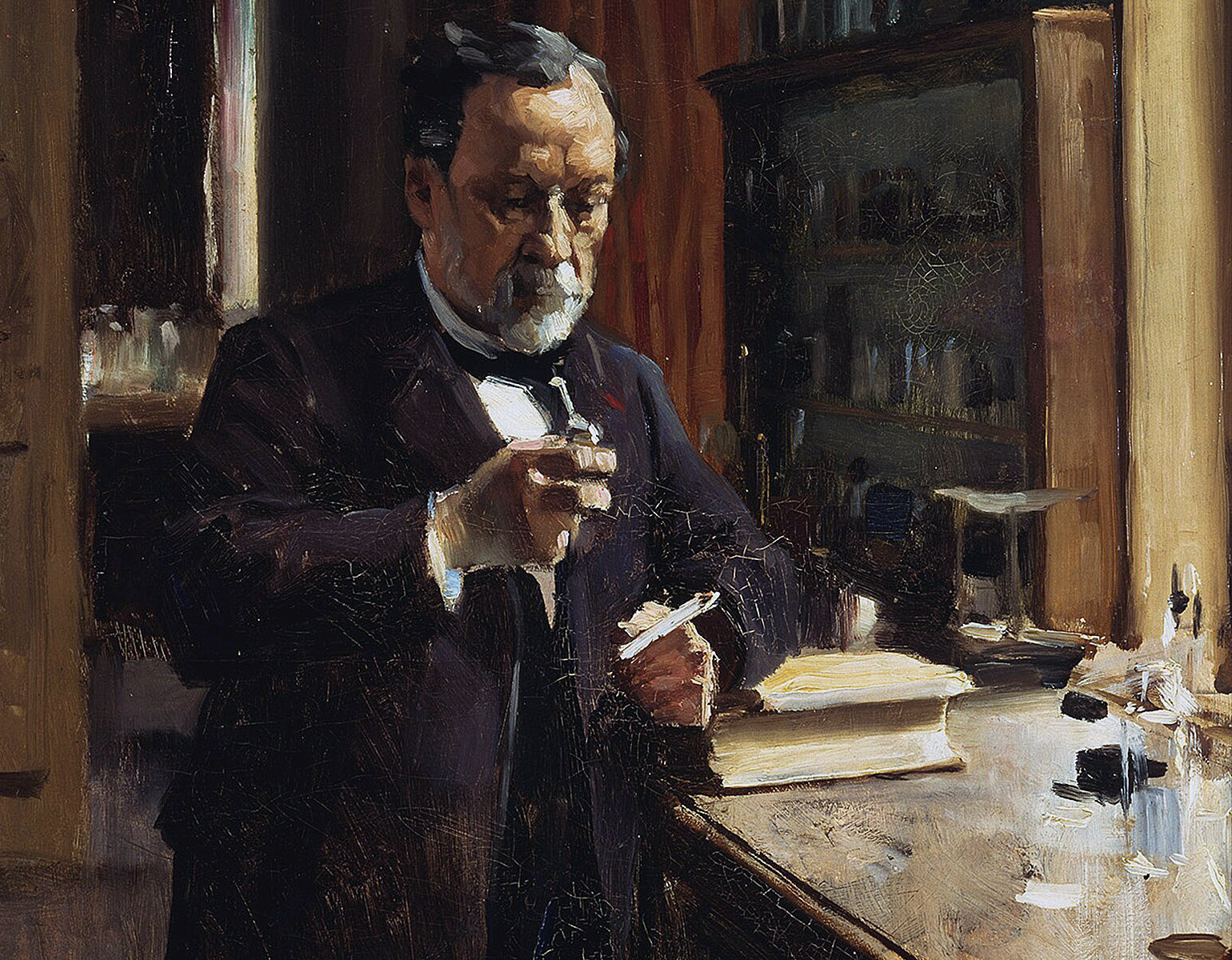 Pasteur vid ett arbetsbord i ett laboratorium.