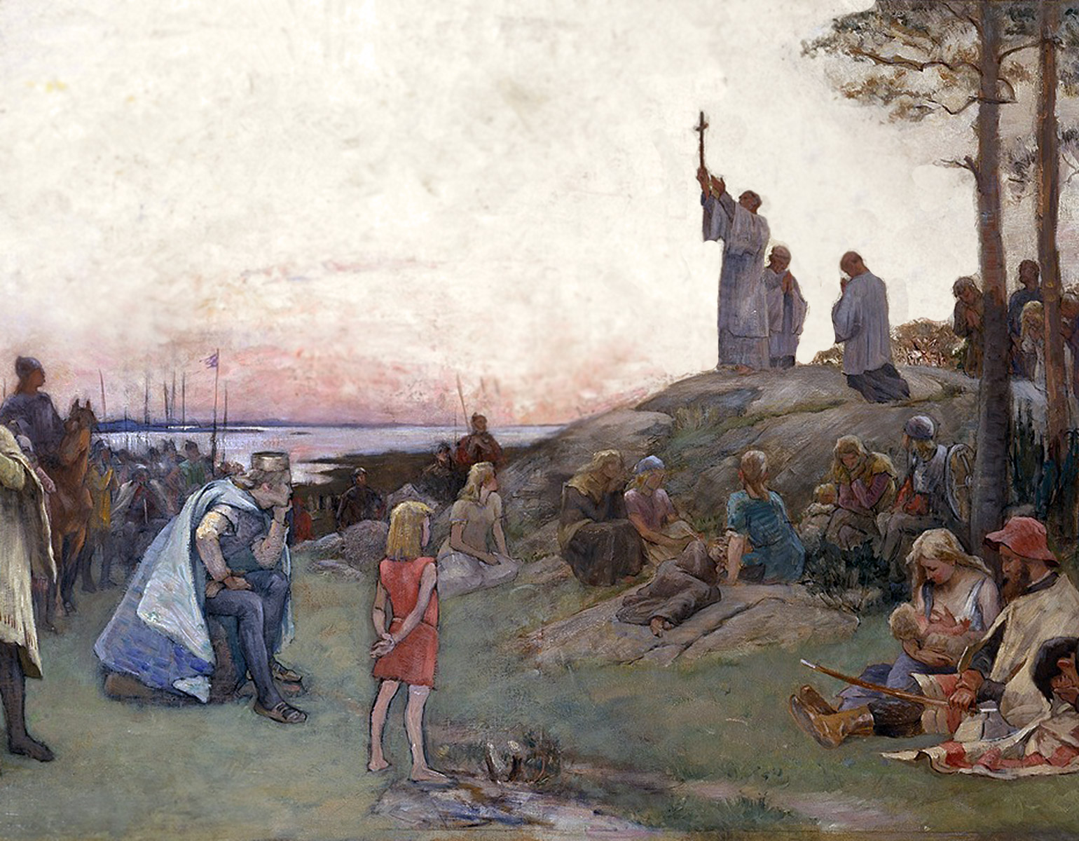 En munk står på en bergshäll och predikar för en folksamling.